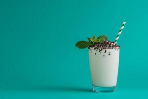 Refreshing Mint Chocolate Milkshake in Glass with Straw. A delicious and cool beverage perfect for summer. photo