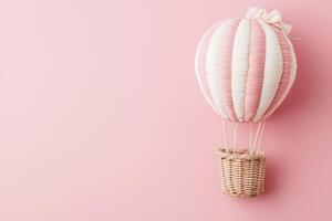 Pink and White Striped Hot Air Balloon with Wicker Basket on Pink Background. A charming illustration perfect for children's themes, travel, or whimsical designs. photo