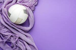 Volleyball and Lavender Fabric on Purple Background Sport and Style Concept. photo