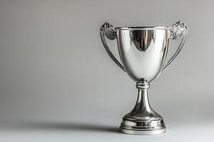 A Shiny Silver Trophy on a Neutral Background. A perfect image for celebrating success and achievement. photo