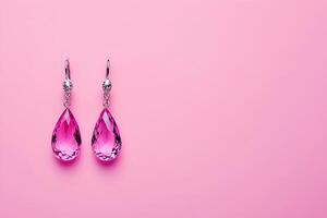 Elegant Pink Gemstone Drop Earrings on Pink Background. These dazzling earrings are perfect for adding a touch of glamour to any occasion. photo