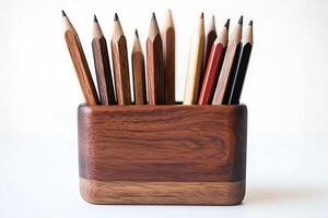 Wooden Pencil Holder with Colorful Pencils. A collection of colored pencils arranged neatly in a handcrafted wooden container. photo