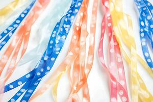 Colorful Polka Dot Ribbons Arranged on White Background. A vibrant collection of pastel ribbons with white polka dots, perfect for crafting and design projects. photo