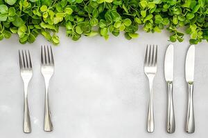 Elegant Table Setting with Fresh Greenery Two Forks, Two Knives, and a Garnish of Green Leaves. photo
