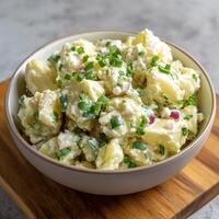 Delicious Potato Salad with Chives and Red Onion in a Bowl. photo