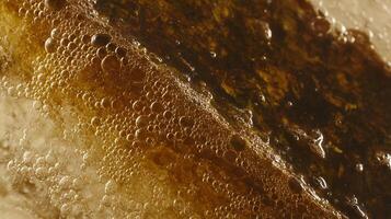 Close Up View Of Amber Bubbles Forming In A Textured Brown Liquid. photo