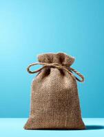 Eco-friendly Burlap Packaging Stands out Against a Bright Blue Background Reflecting Sustainability and Natural Materials photo