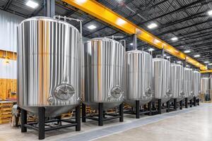 Large steel tanks standing in modern food processing plant photo