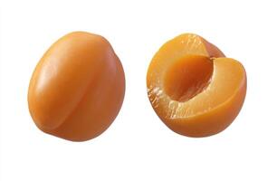 Close-up of two ripe apricots, one whole and one halved, against a plain white background photo