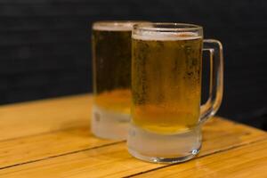 Two mugs of beer on a table photo