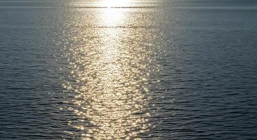 A boat is in the water with the sun shining on it photo