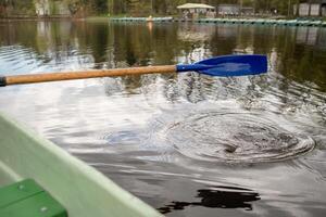 Rowing Activity on a Calm Lake With a Visible Splash and Ripples From an Oar Late in the Afternoon photo