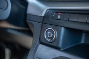 Close-up View of an Ignition Button in a Vehicles Interior During a Bright and Sunny Day photo