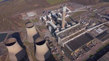 Industrial cooling towers and turbine generators in power plant Nottingham drone shot video