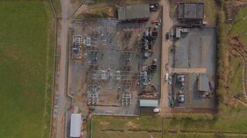 Large power substation with electrical grid transformers England from drone video
