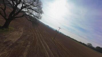 FPV drone dynamic fast flying over rural winter landscape with trees video