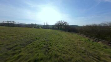 Cinematic fast FPV aerial footage near trees in rural winter spring video