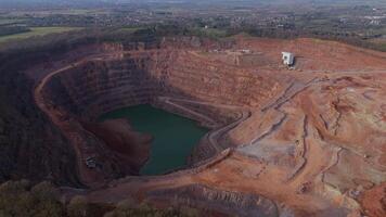 Wide drone view of quarry mining site with heavy machinery and raw materials video