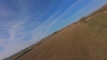 FPV drone dynamic flight over rural winter farmland and bare trees video