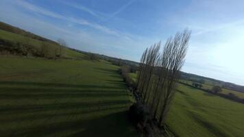 Aerial FPV drone footage flying near trees in early spring countryside video