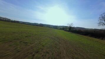 Fast FPV drone flight over countryside trees and rolling fields winte video