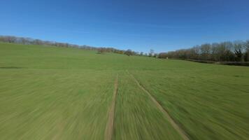 FPV drone flight following countryside farmland landscape England video