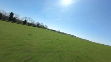 Smooth FPV drone footage flying near crops and farmland England UK video