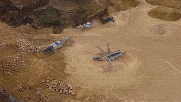 Aerial landscape of quarry mining operation with trucks and diggers England video