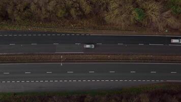 Flying drone view of large highway roundabout and traffic in UK Spring video
