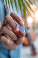 Unique guitar pick design showcased in tropical setting with ample advertisement space photo