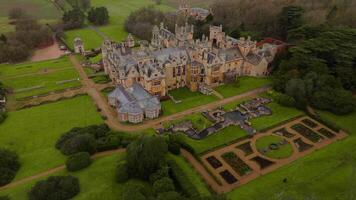 Drone view of ornate Harlaxton Manor mansion in natural rural surroundings video