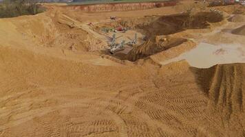 Birdseye drone view of iron ore and coal extraction site with excavators England video