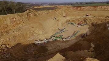 Overhead drone shot of industrial quarry site with mining gear England video