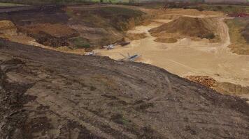 Aerial footage showing iron ore and coal quarry with excavation vehicles England video