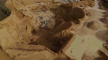 Quarry with industrial trucks and loading machinery in aerial footage England video