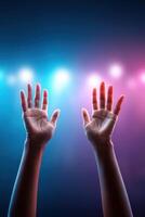 Engaging hands gesture passionately during a public speaking event under vibrant lighting photo