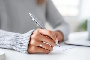 Stylish pen poised for writing in modern workspace with bright background and ample copy space photo
