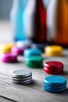 Colorful bottle caps create a vibrant and cheerful display on a wooden surface in a bright light photo