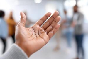 Hands reaching out to connect in a bright workspace, fostering community among employees photo