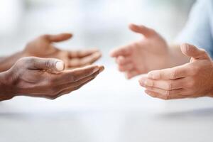 Close-up of hands engaging in dialogue to resolve conflicts through effective communication strategies photo