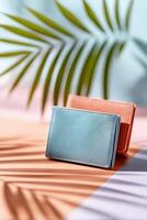 Modern business card holder with colorful backdrop and palm shadows in creative workspace setting photo