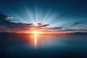 Radiant sunrise over mountains and ocean with vibrant light beams illuminating the sky photo