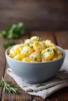 Homemade potato salad with fresh herbs presented on a picnic table for a summer gathering photo