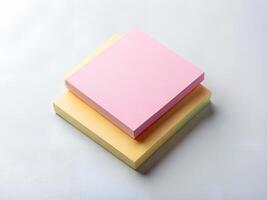 Pastel Pink and Yellow Sticky Notes Stacked on White Background photo