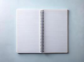Blank Lined Notebook Open on Pale Blue Textured Background photo