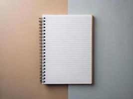 Blank Spiral Notebook on Beige and Blue Background photo