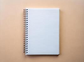 an open notebook with a spiral notebook on a beige background photo