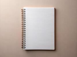 Blank Spiral Notebook with Rose Gold Binding on Beige Background photo