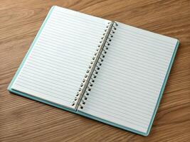 Open Light Blue Dotted Notebook on Wooden Desk photo