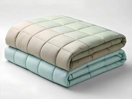 Two Soft Quilted Blankets in Beige and Teal Shades on White Background photo